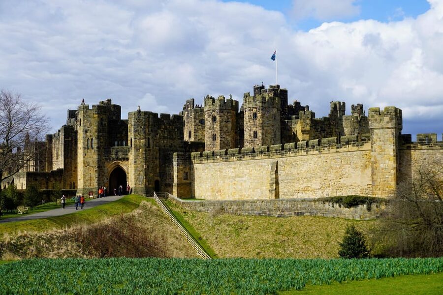 Edinburgh: Bamburgh Castle, Northumberland and Alnwick Trip - Bamburgh Castle above the coast