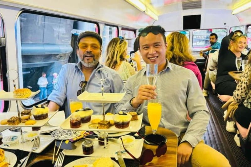 London: "Here We Go Again" Afternoon Tea Bus - Afternoon tea with scones, sandwiches, and prosecco